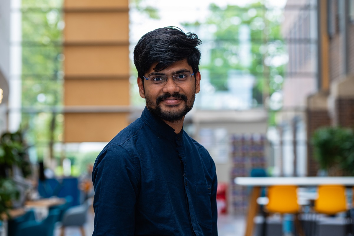 Smiling male student with beard looking towards camera